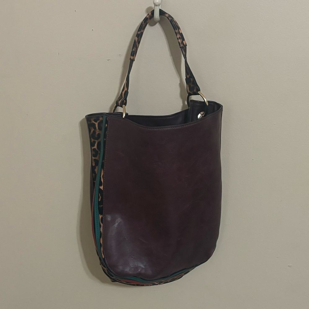 Deep burgundy tote bag with leopard print side panels and outside zipper pocket